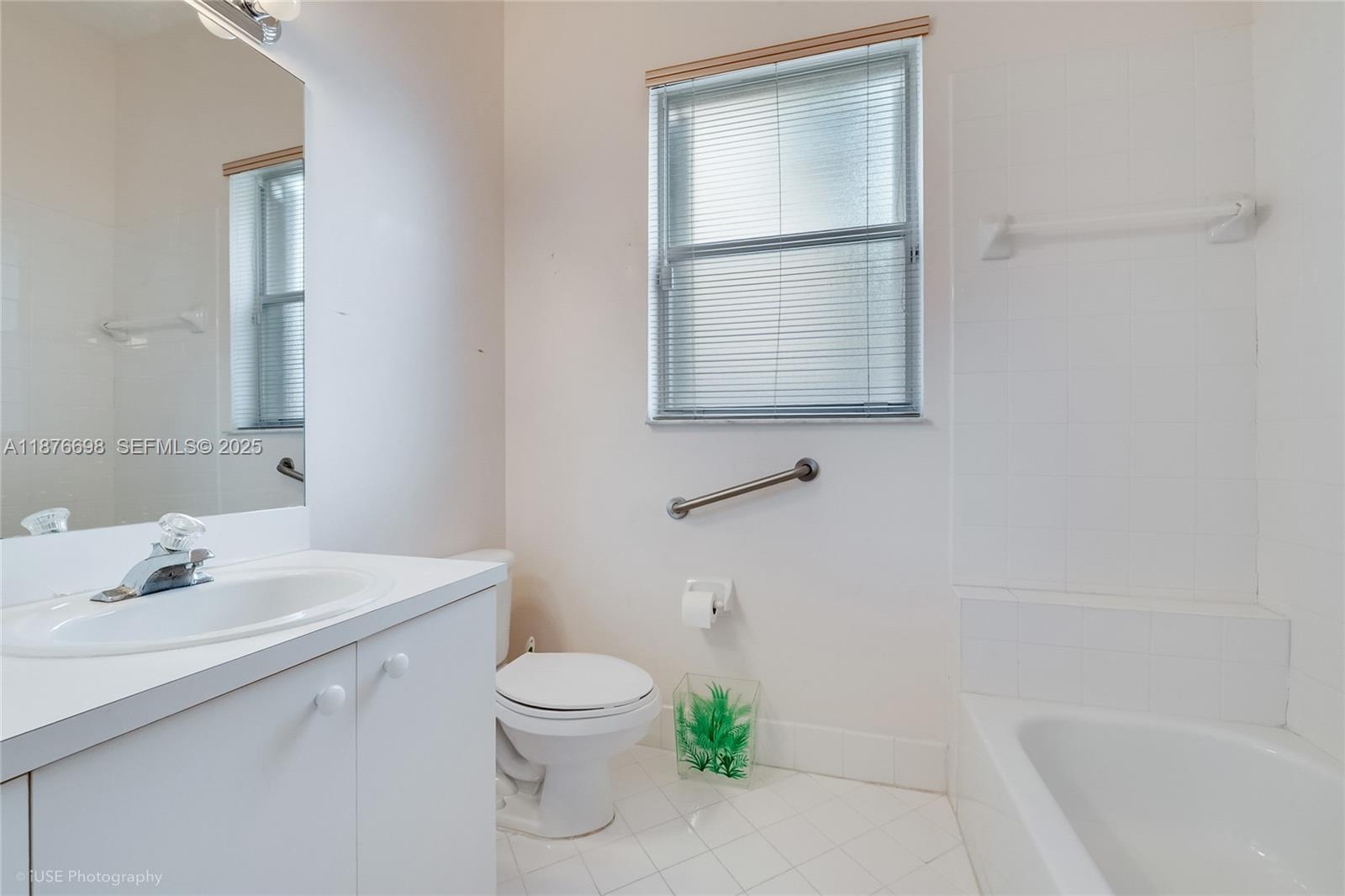 15503 Southwest 151st Street Miami, FL 33196 - Photo 13 of 16 a bathroom with a sink a toilet and shower