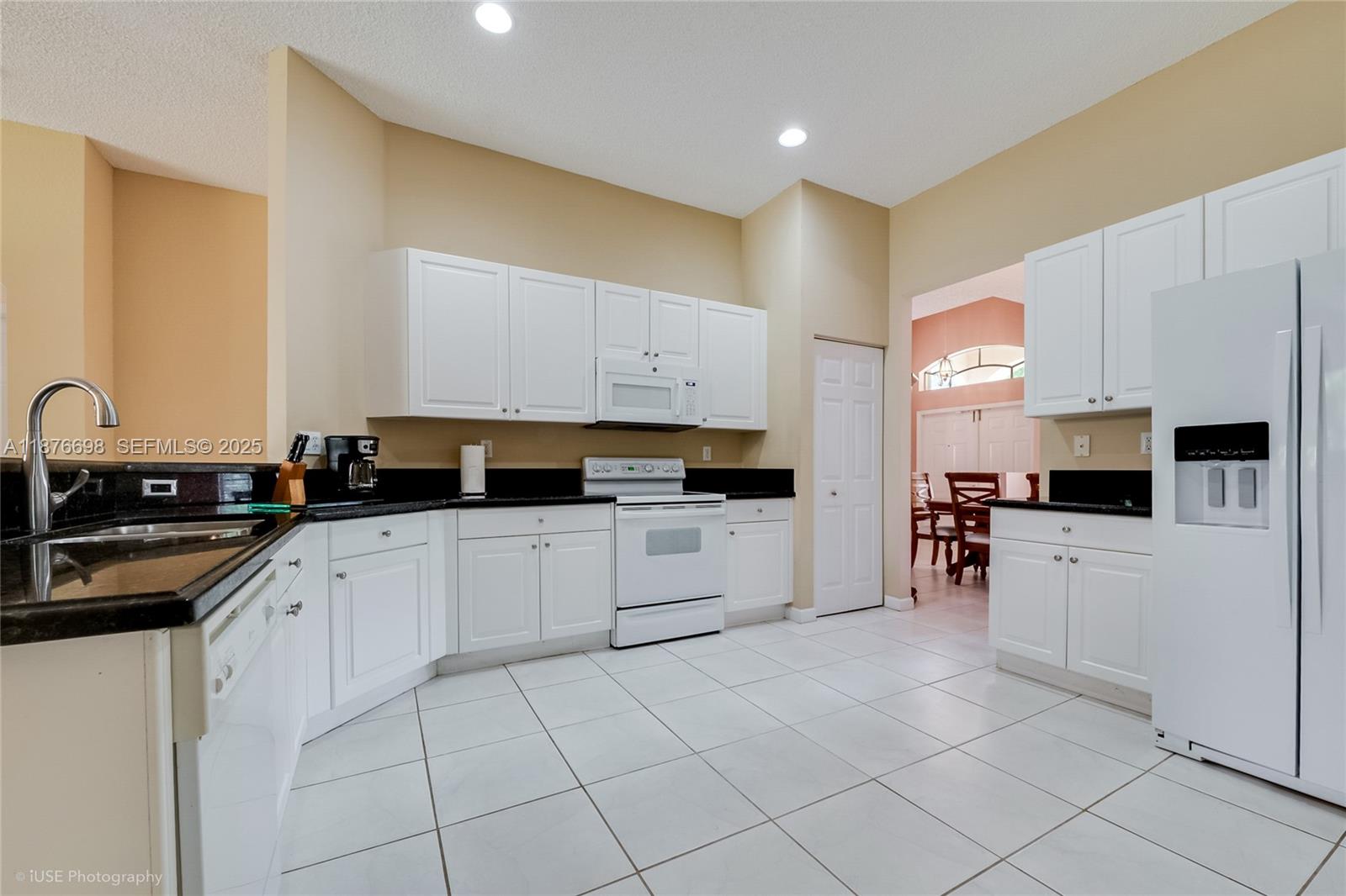 15503 Southwest 151st Street Miami, FL 33196 - Photo 4 of 16 a kitchen with white cabinets sink and stainless steel appliances