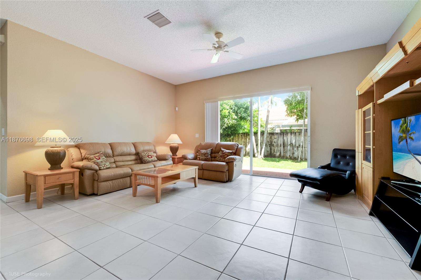 15503 Southwest 151st Street Miami, FL 33196 - Photo 5 of 16 a living room with furniture and a flat screen tv