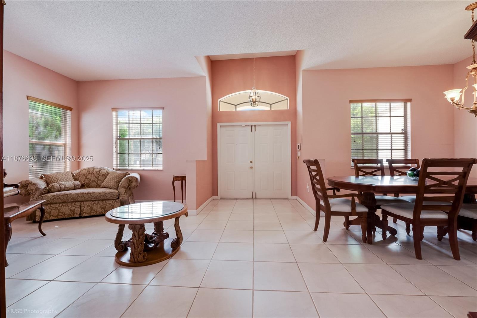 15503 Southwest 151st Street Miami, FL 33196 - Photo 6 of 16 a living room with furniture a dining table and a window