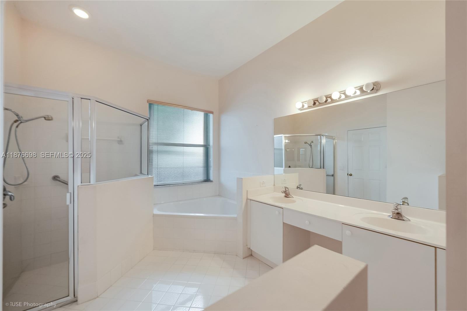 15503 Southwest 151st Street Miami, FL 33196 - Photo 10 of 16 a bathroom with a tub sink shower and mirror