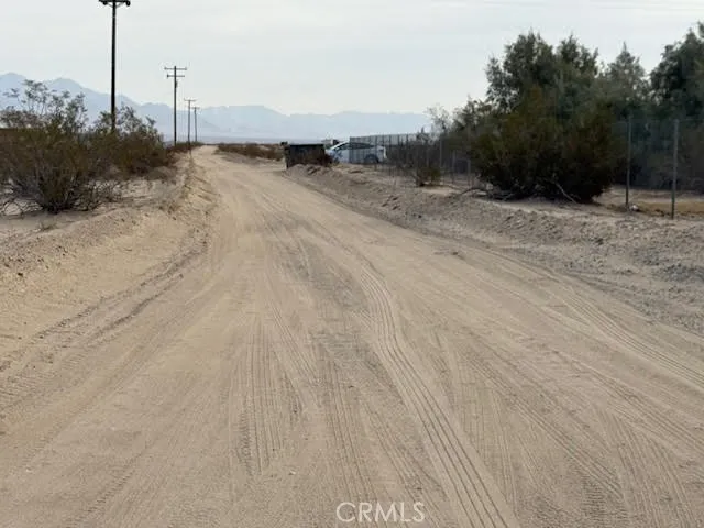 123 Meriwether Road Twentynine Palms, CA 92277 - Photo 3 of 9 a view of a dry yard with a road