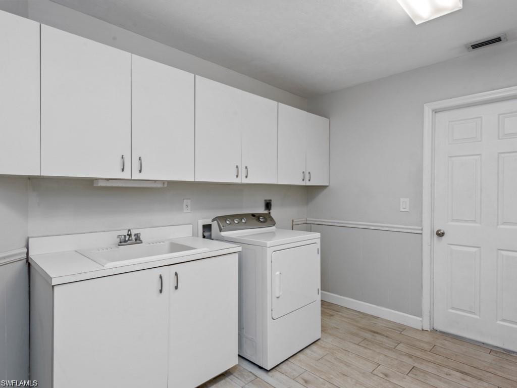 7016 Trail Boulevard Naples, FL 34108 - Photo 19 of 25 a view of a storage and utility room with washer and dryer