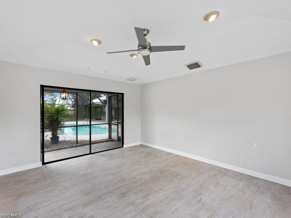 7016 Trail Boulevard Naples, FL 34108 - Photo 23 of 25 wooden floor in an empty room with a sliding door