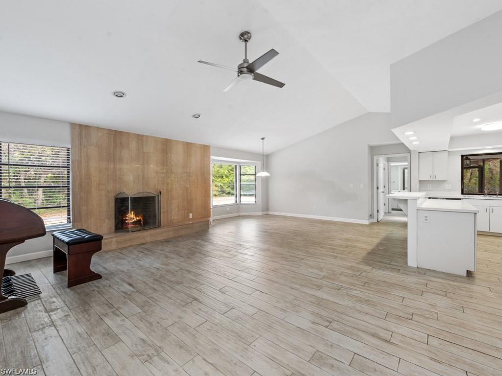 7016 Trail Boulevard Naples, FL 34108 - Photo 7 of 25 a view of an empty room with a fireplace and a window
