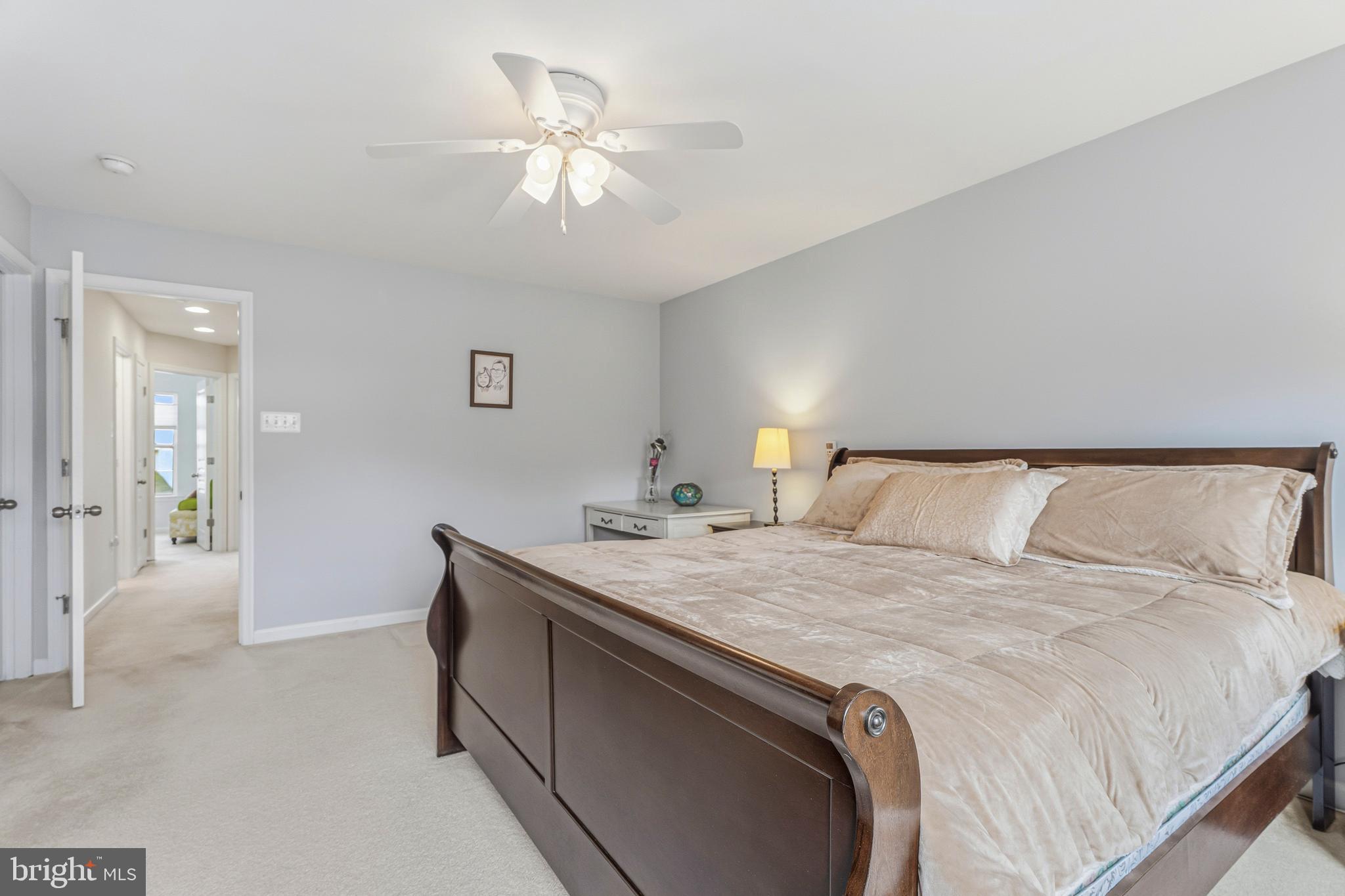 8876 Paddock Lane Baltimore, MD 21234 - Photo 16 of 37 a bedroom with a bed and a chandelier