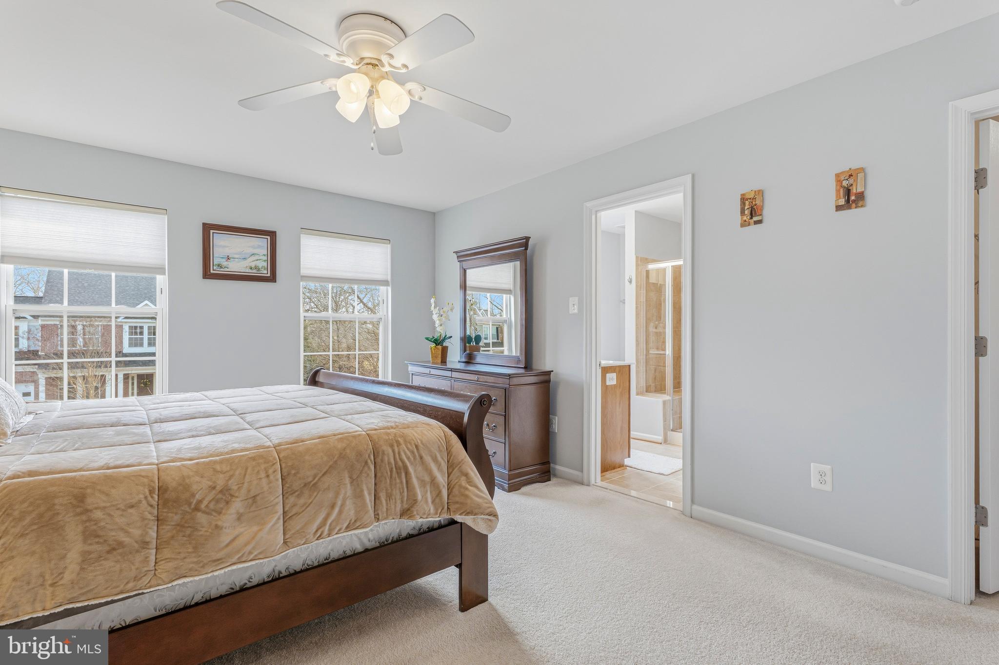 8876 Paddock Lane Baltimore, MD 21234 - Photo 17 of 37 a bedroom with a bed and a chandelier