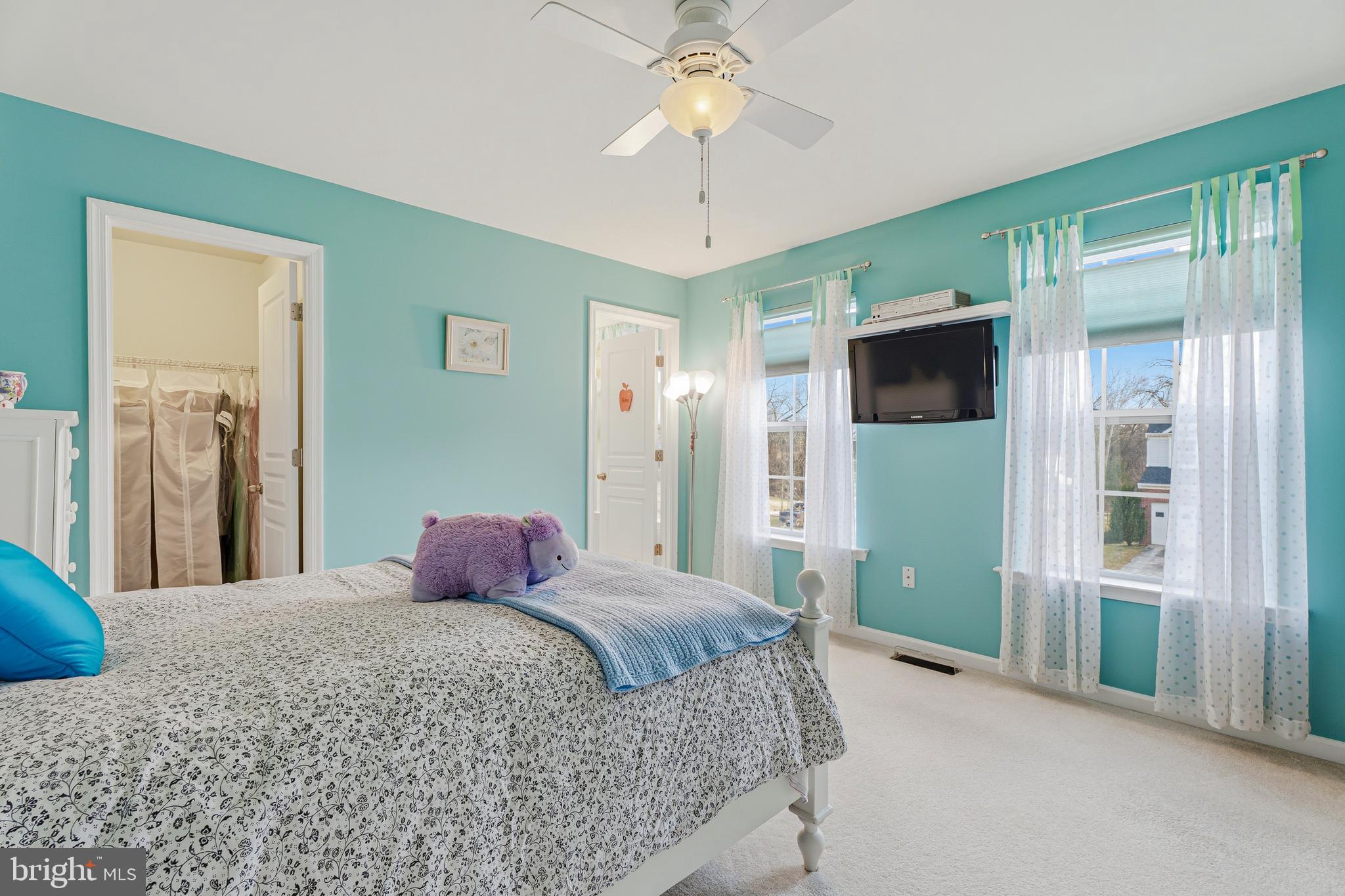 8876 Paddock Lane Baltimore, MD 21234 - Photo 26 of 37 a bedroom with a bed bathroom and a chandelier