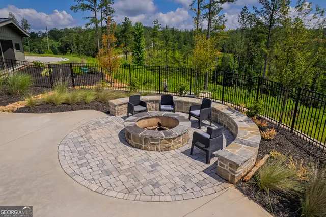 a view of a swimming pool with a patio and a garden