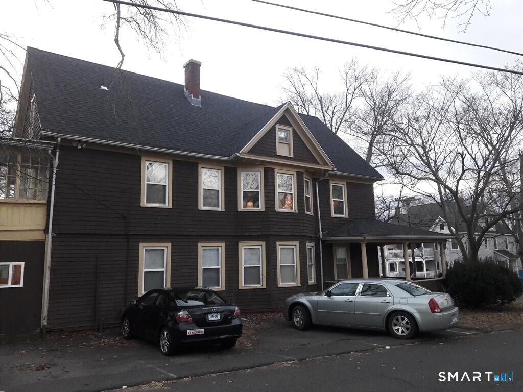 64-66 Ridge Street Manchester, CT 06040 - Photo 2 of 21 a couple of cars parked in front of a house