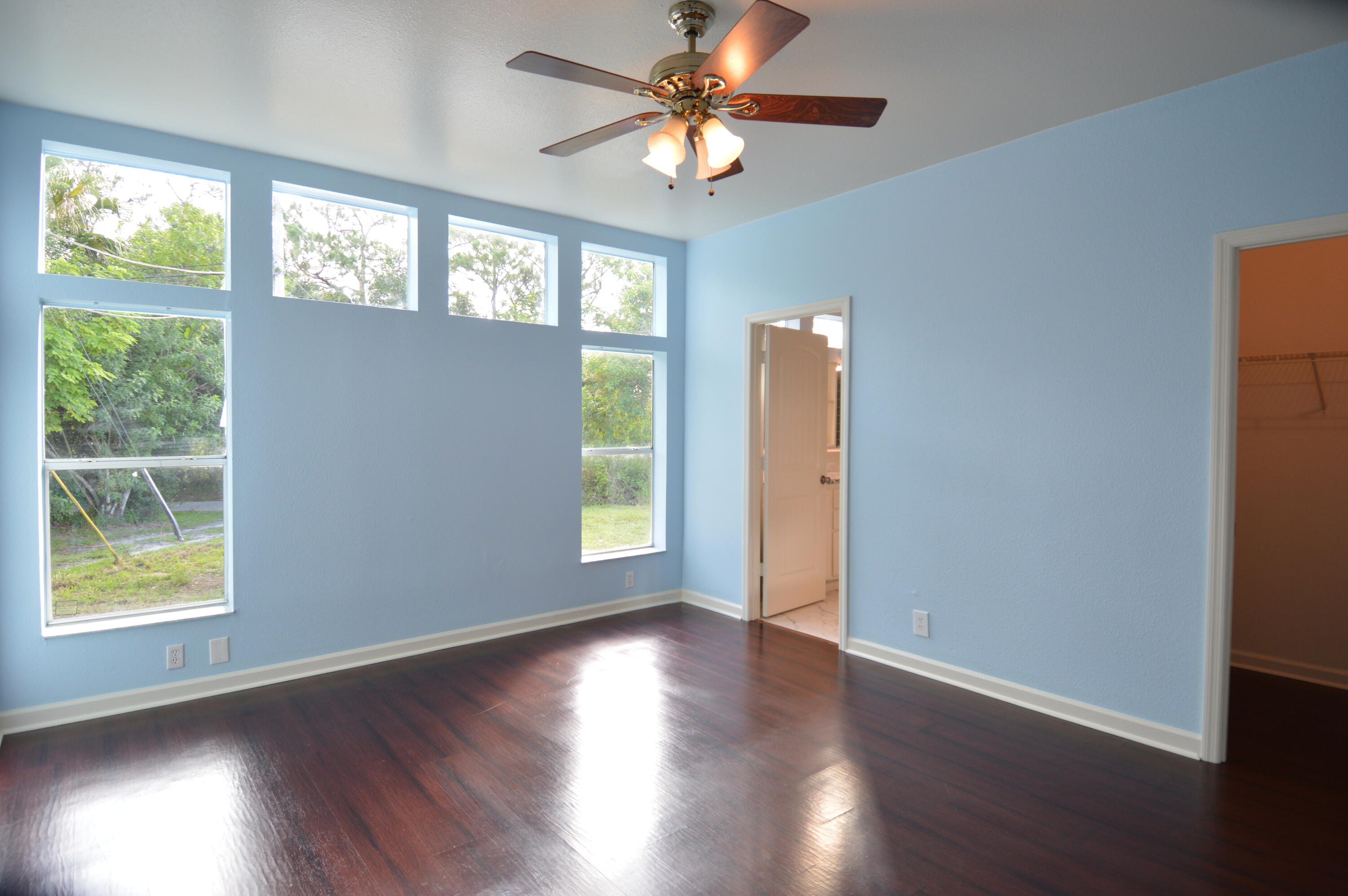 1201 Southwest Sunshine Street Stuart, FL 34997 - Photo 18 of 41 a view of an empty room with wooden floor and a window