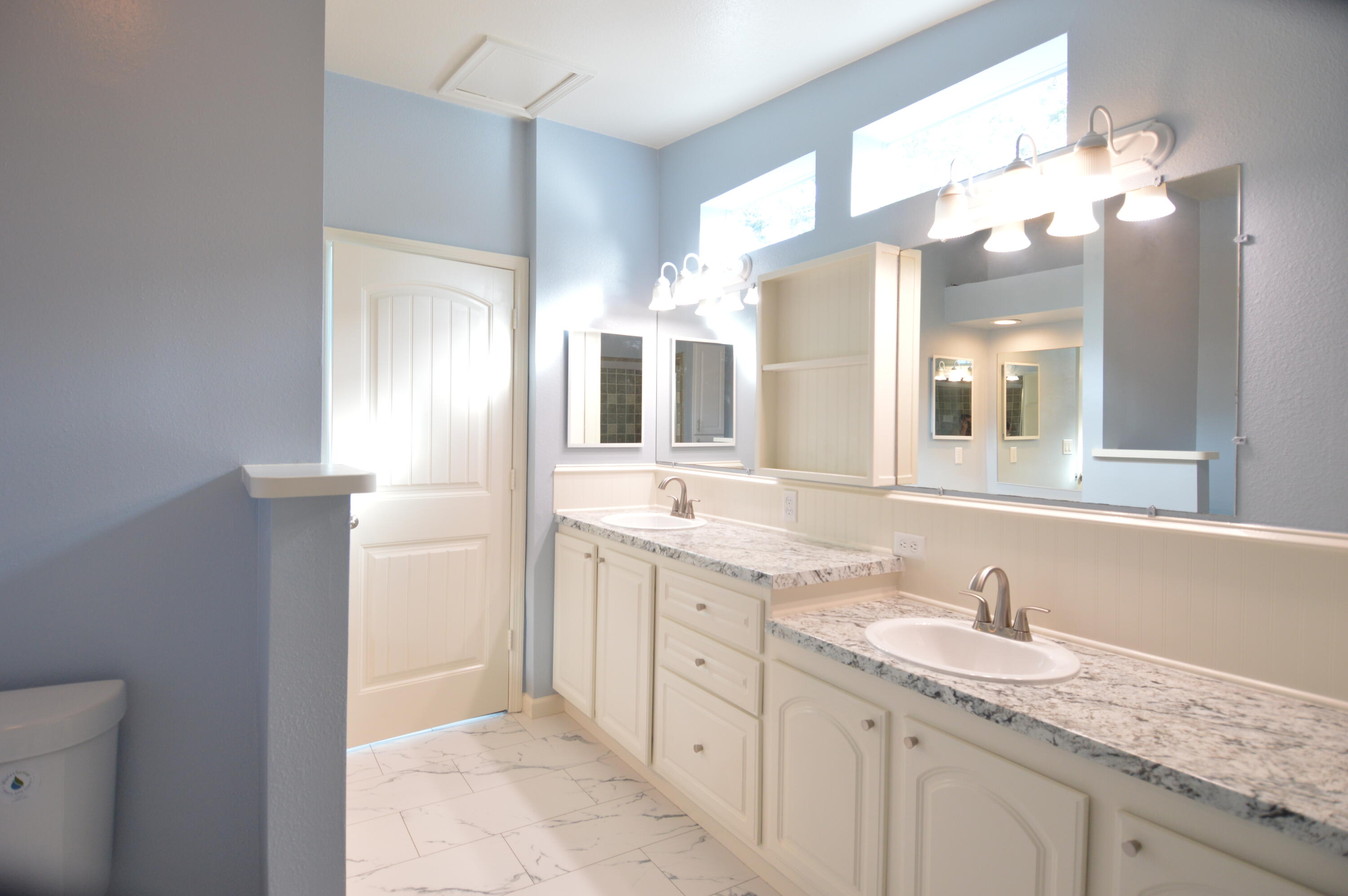 1201 Southwest Sunshine Street Stuart, FL 34997 - Photo 20 of 41 a bathroom with a granite countertop sink mirror and double