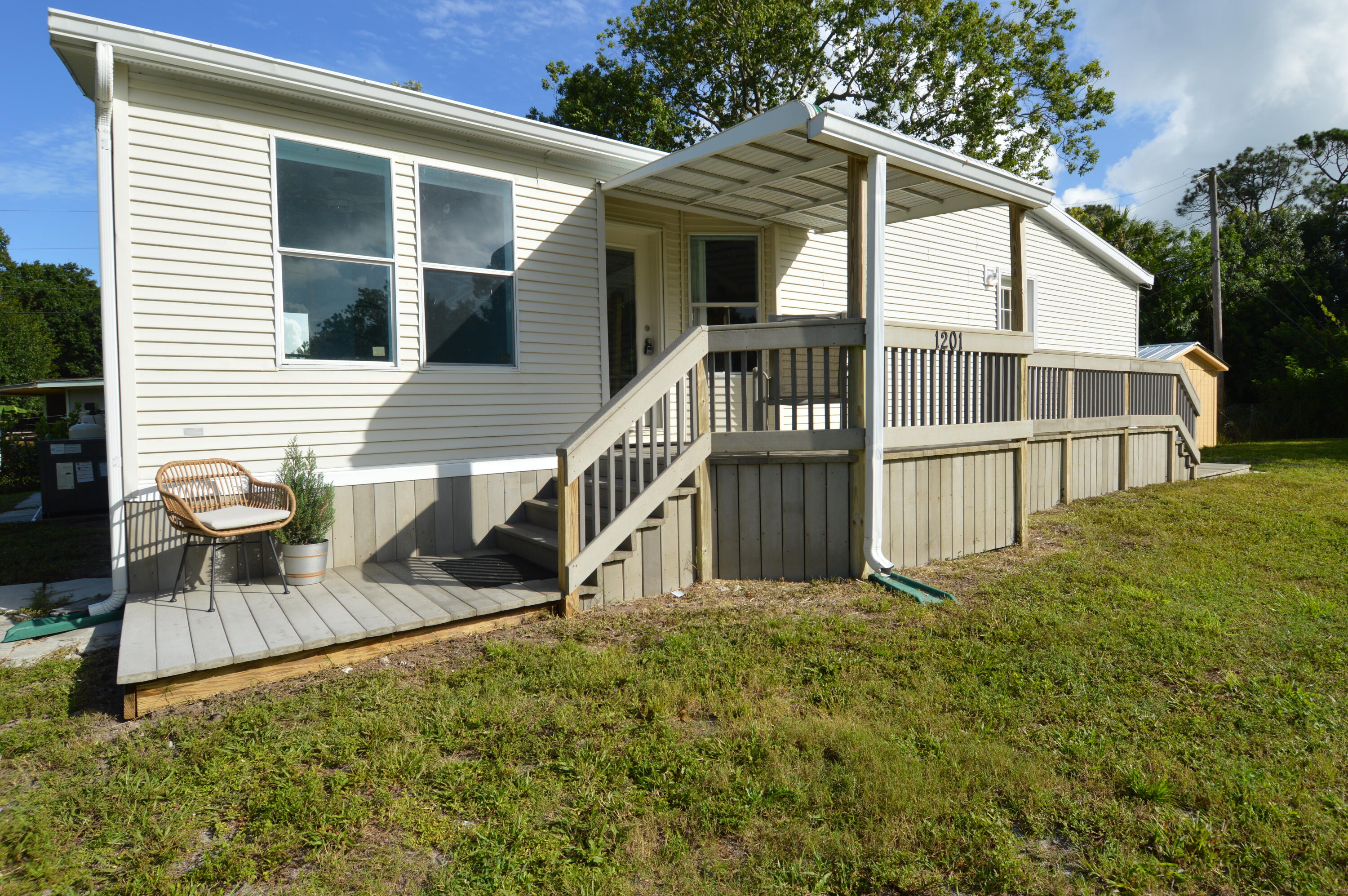 1201 Southwest Sunshine Street Stuart, FL 34997 - Photo 2 of 41 a view of a house with backyard and porch
