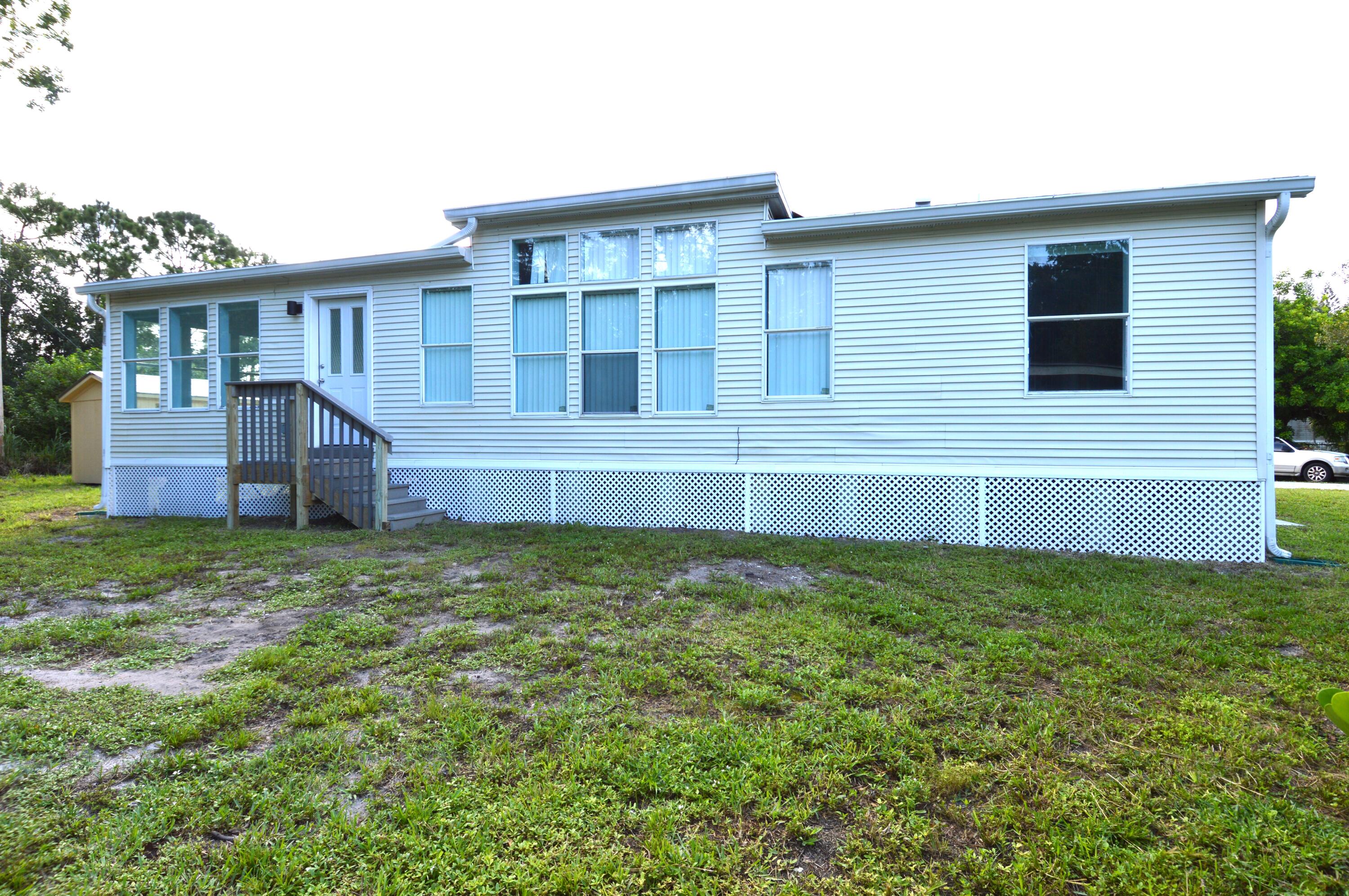 1201 Southwest Sunshine Street Stuart, FL 34997 - Photo 34 of 41 a view of a house with a backyard