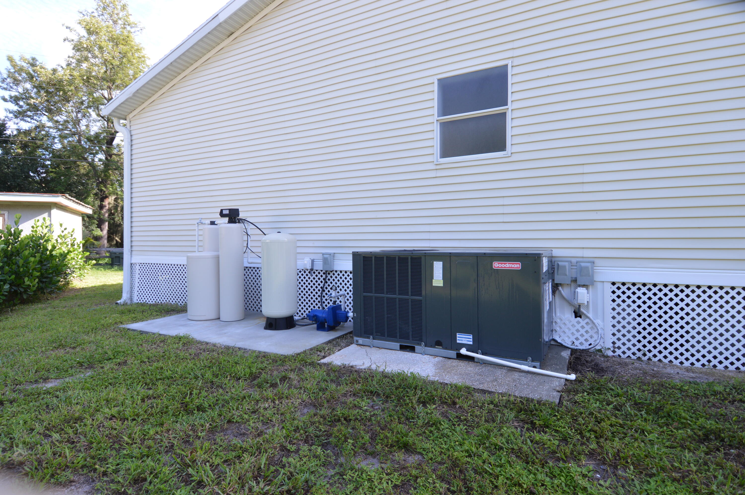1201 Southwest Sunshine Street Stuart, FL 34997 - Photo 36 of 41 a front view of a house with a yard and garage