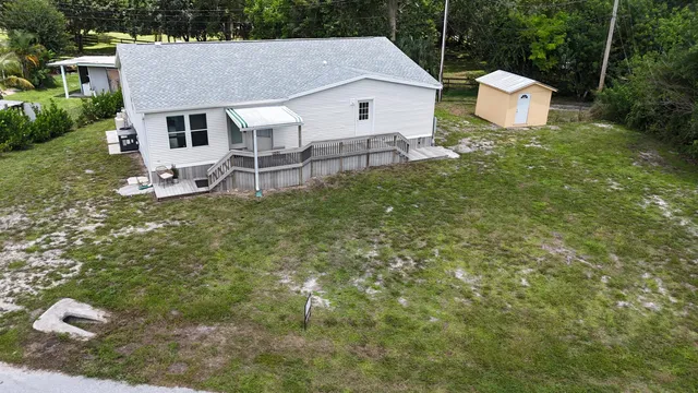 a aerial view of a house with a yard and sitting area