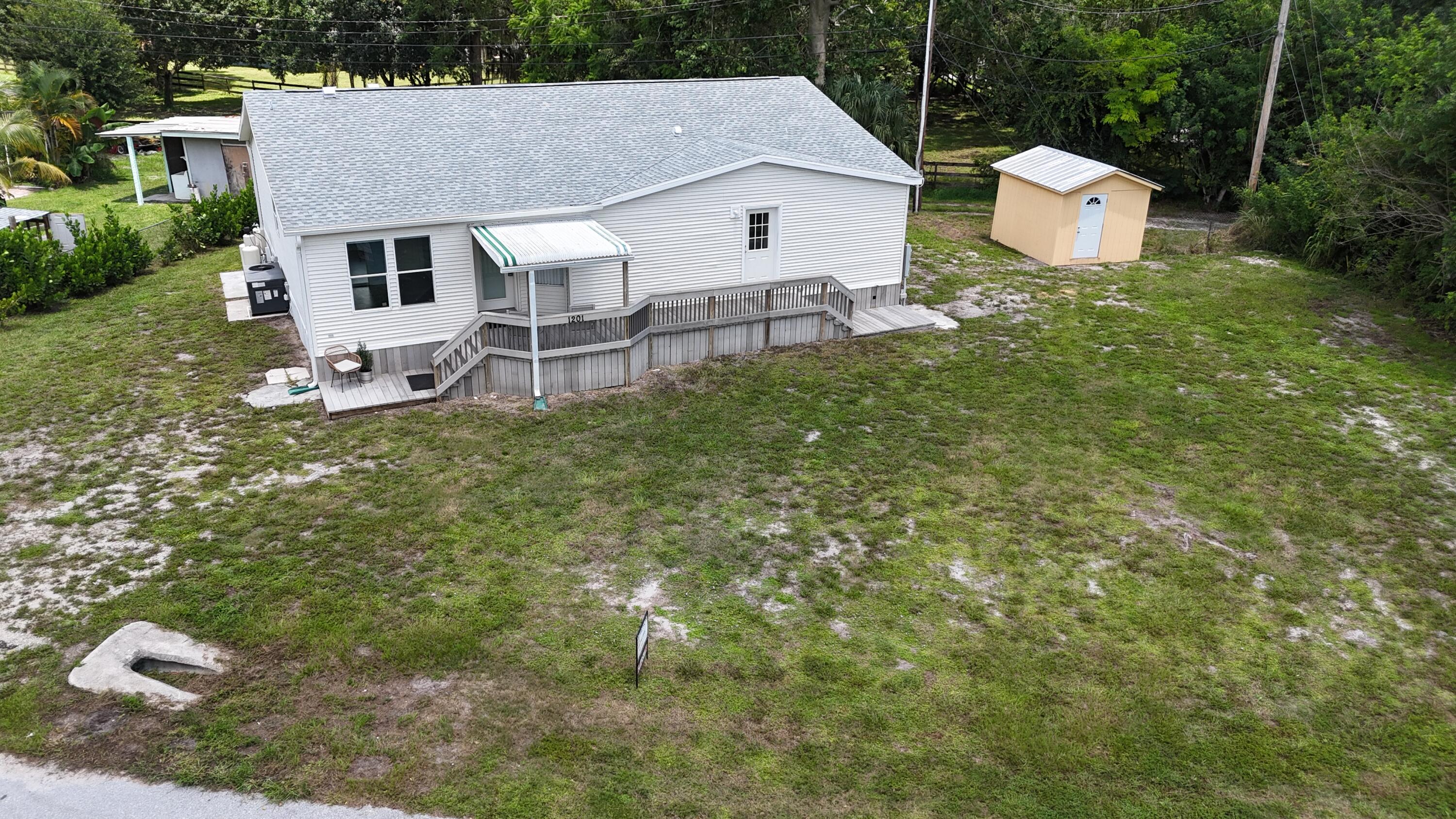 1201 Southwest Sunshine Street Stuart, FL 34997 - Photo 39 of 41 a aerial view of a house with a yard and sitting area
