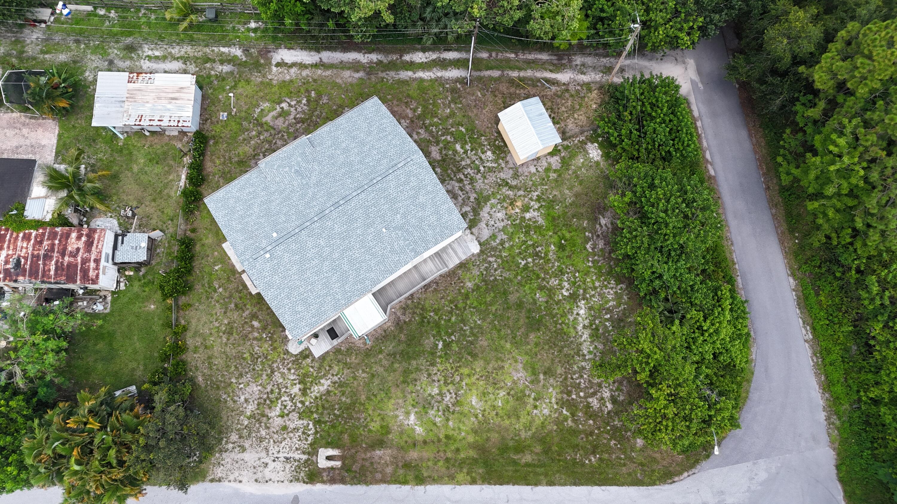 1201 Southwest Sunshine Street Stuart, FL 34997 - Photo 40 of 41 an aerial view of a house with a yard and lake view