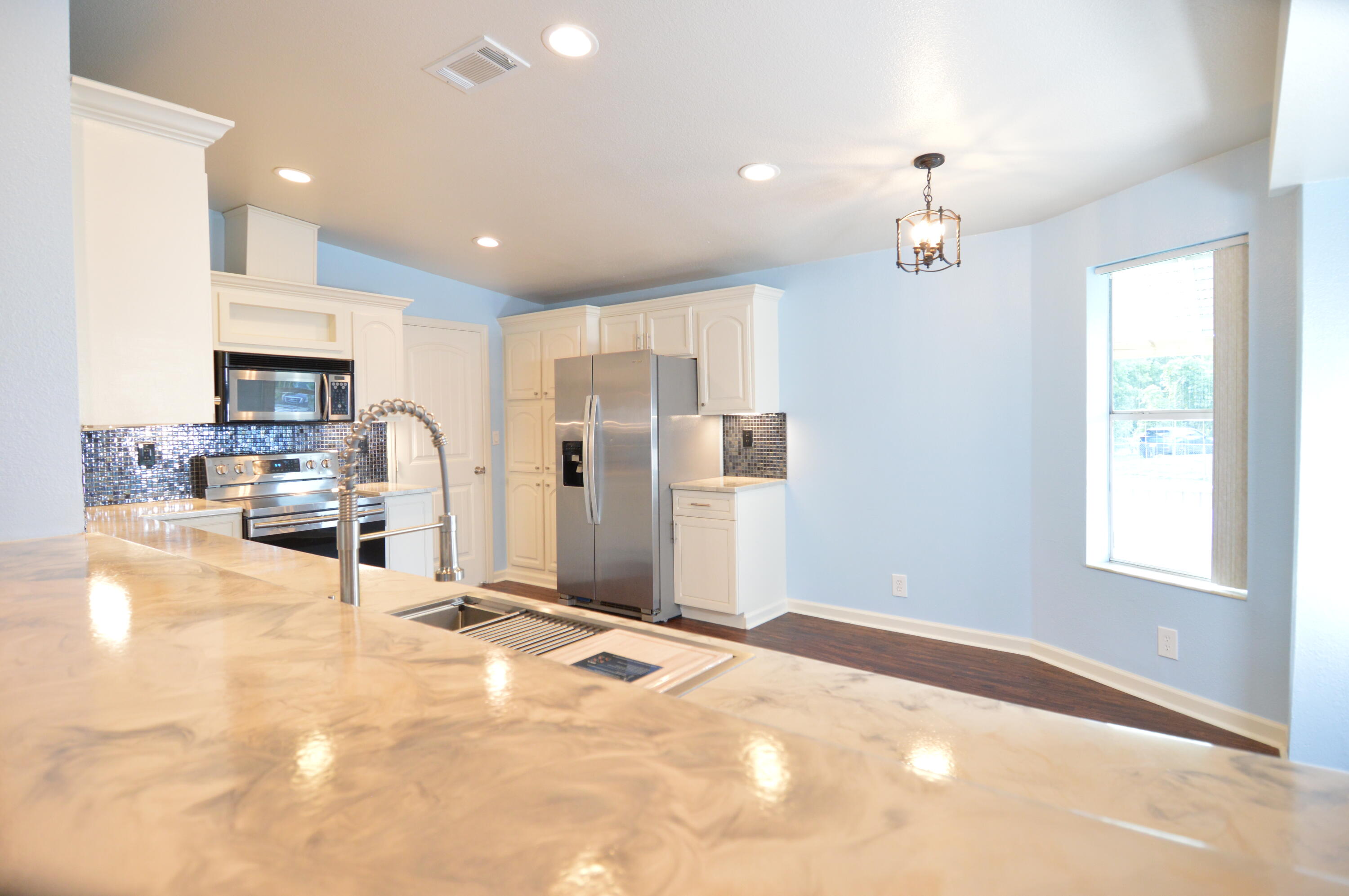 1201 Southwest Sunshine Street Stuart, FL 34997 - Photo 9 of 41 a view of a kitchen with a sink and a window