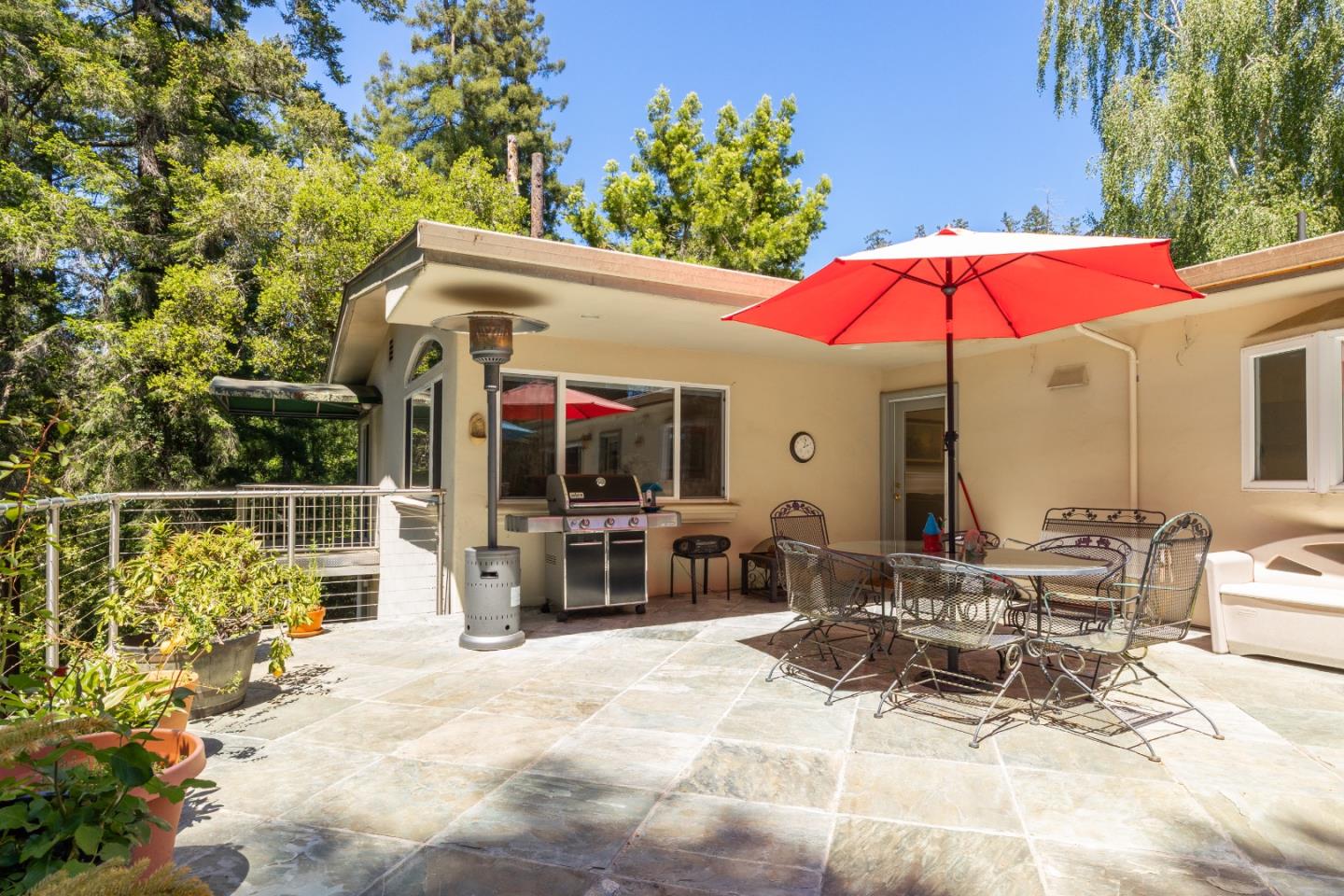 2000 Glen Canyon Road Santa Cruz, CA 95060 - Photo 36 of 41 a view of a patio with a table and chairs under an umbrella