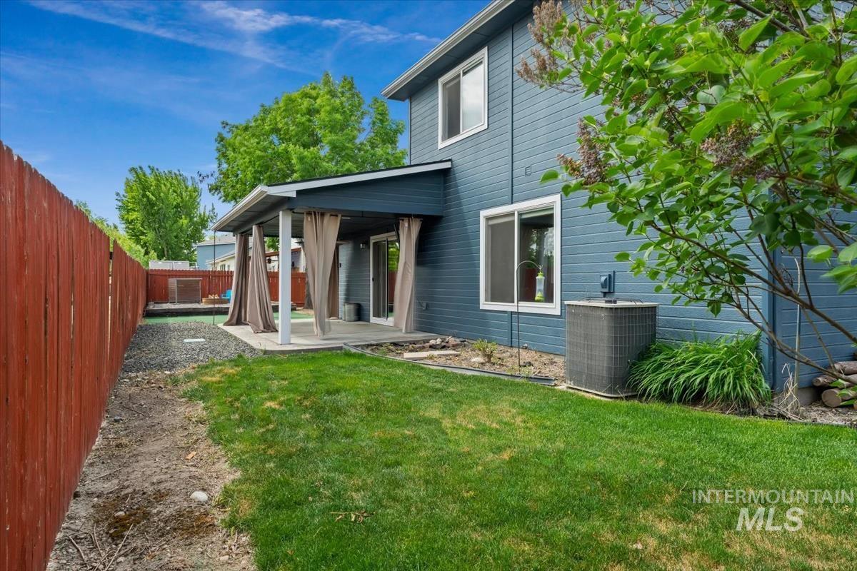 80 Cobblestone Court Middleton, ID 83644 - Photo 37 of 48 Expansive backyard featuring a covered patio, manicured lawn, and a wooden privacy fence