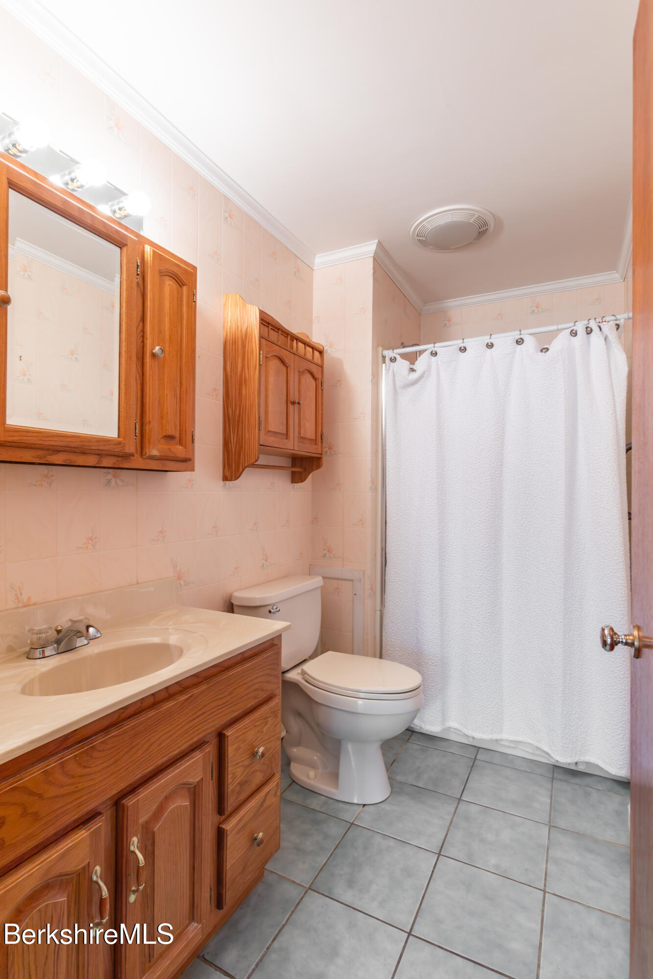 25 Robert Street Pittsfield, MA 01201 - Photo 14 of 19 a bathroom with a sink toilet a mirror and shower