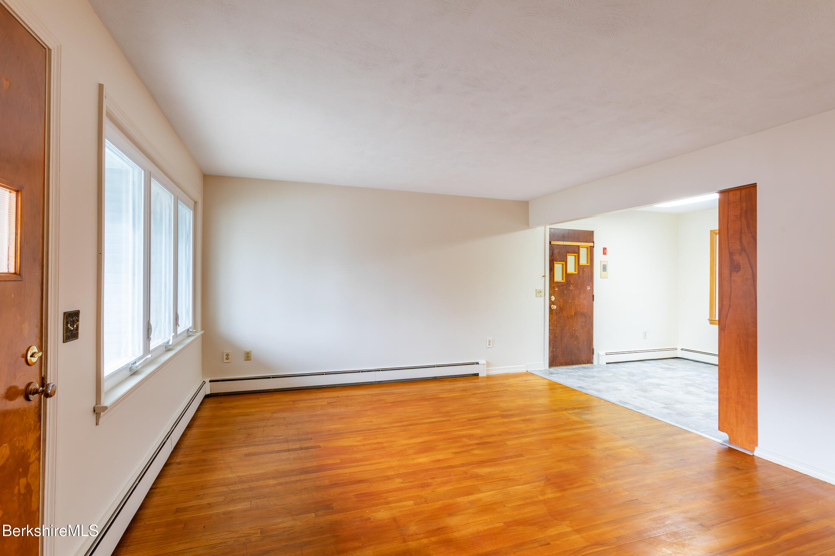25 Robert Street Pittsfield, MA 01201 - Photo 8 of 19 a view of an empty room with wooden floor and a window