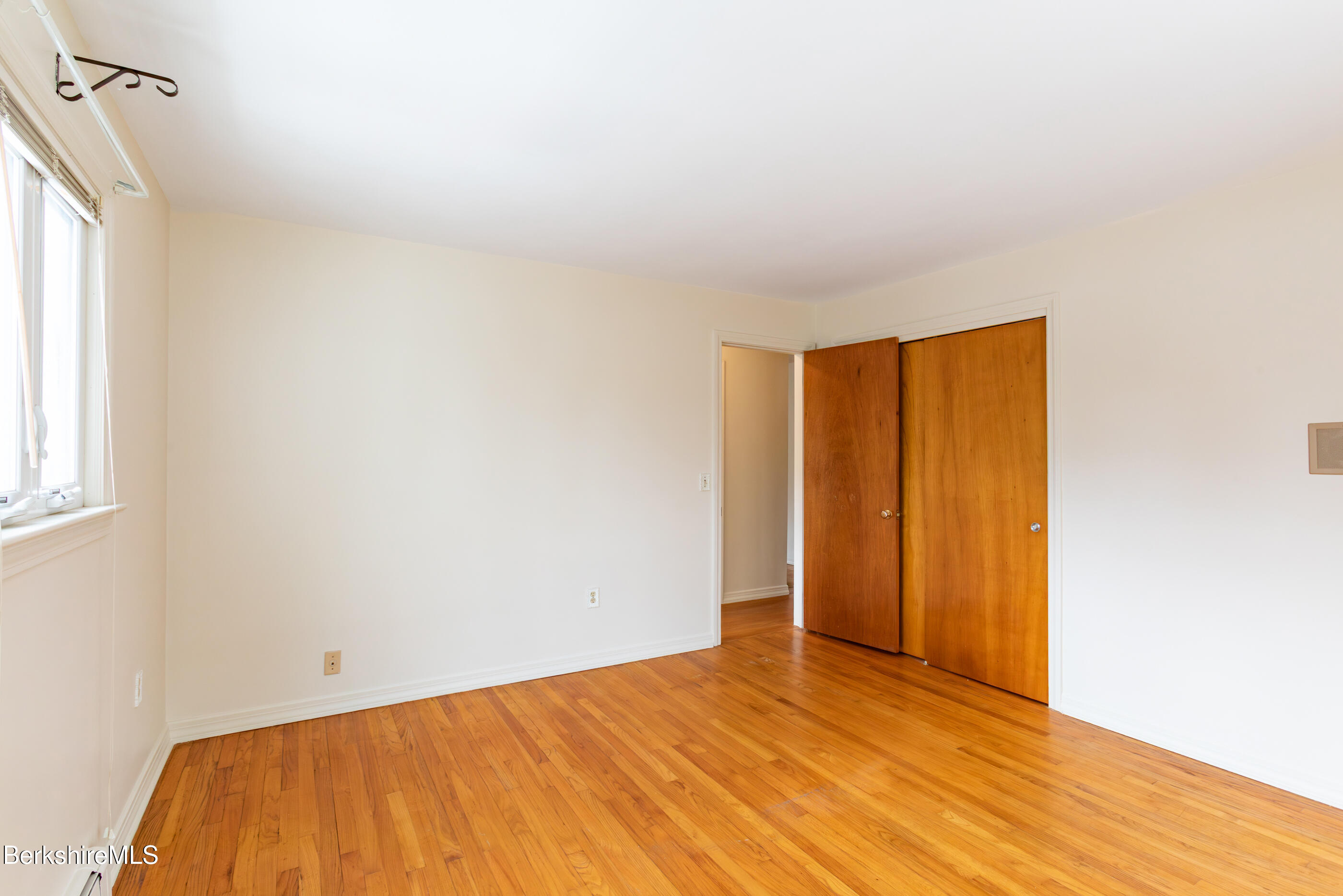 25 Robert Street Pittsfield, MA 01201 - Photo 10 of 19 a view of empty room with wooden floor and fan