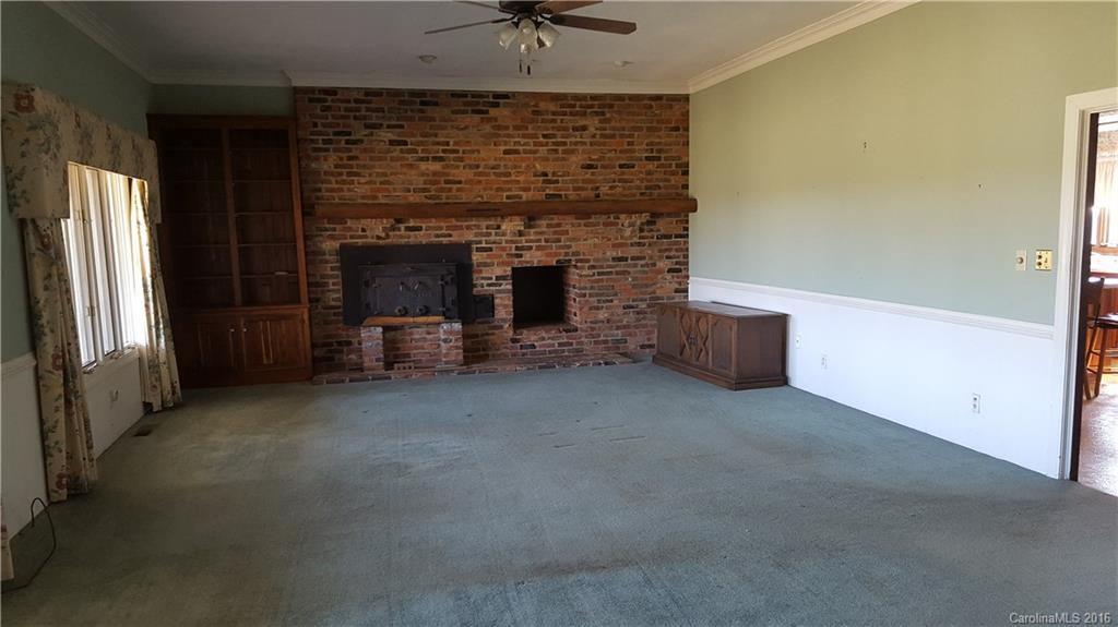 13531 Cabarrus Station Road Midland, NC 28107 - Photo 4 of 14 an empty room with a fireplace and entryway