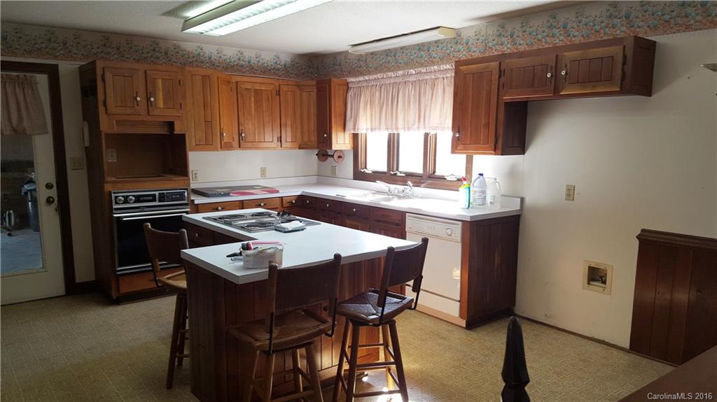13531 Cabarrus Station Road Midland, NC 28107 - Photo 7 of 14 a kitchen with a stove a sink and a refrigerator