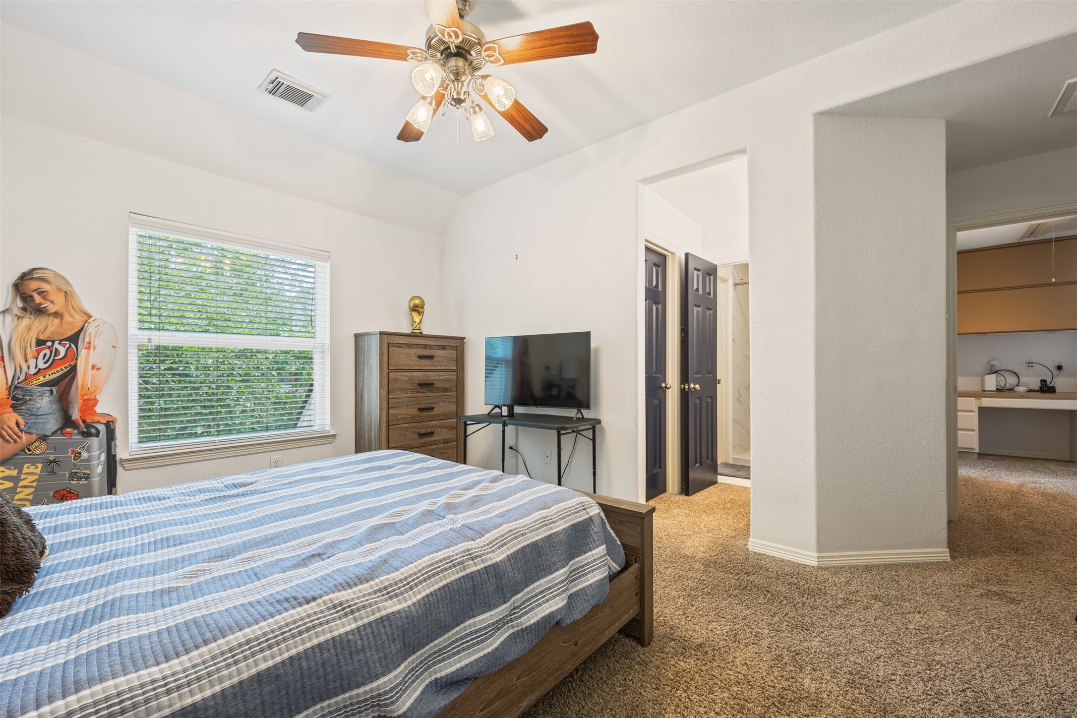 58 South Longsford Circle Spring, TX 77382 - Photo 25 of 50 a bedroom with a bed and a flat screen tv