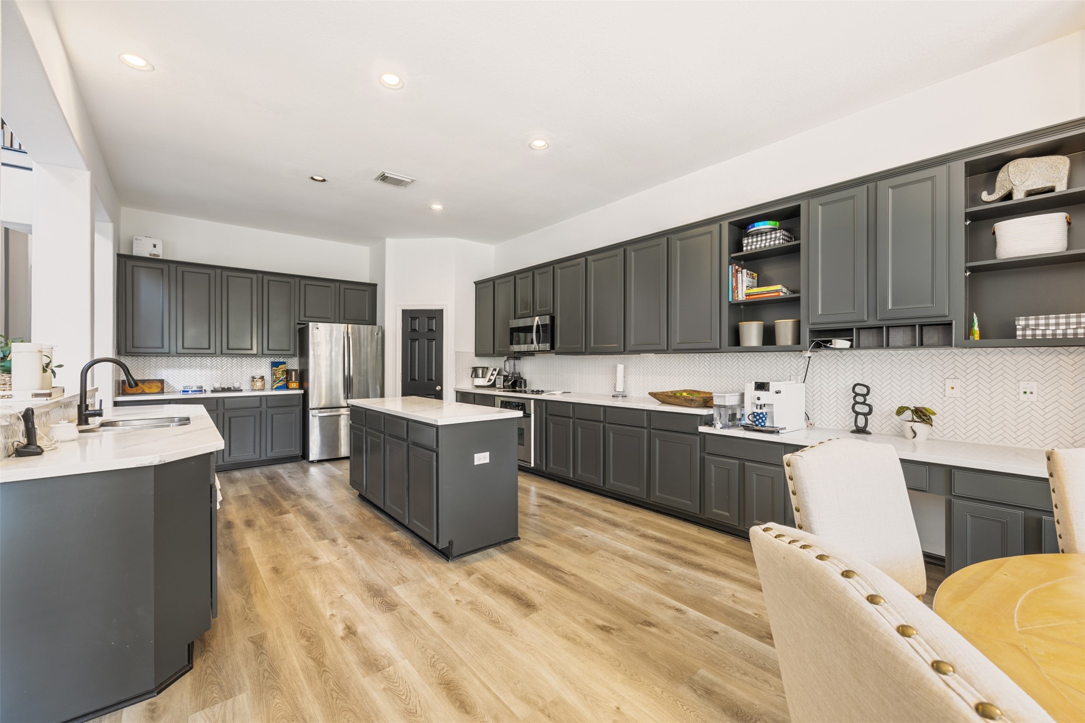 58 South Longsford Circle Spring, TX 77382 - Photo 29 of 50 a kitchen with a sink a counter top space stainless steel appliances and cabinets