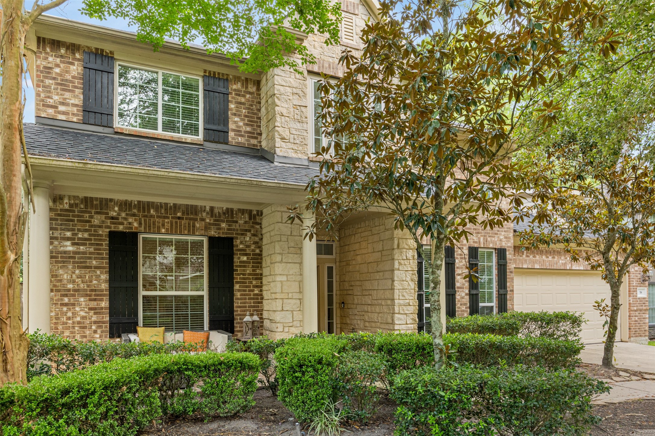58 South Longsford Circle Spring, TX 77382 - Photo 3 of 50 front view of a brick house with a large windows and a large tree