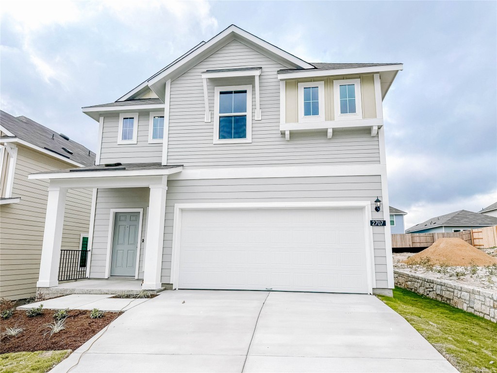a front view of a house with a garage