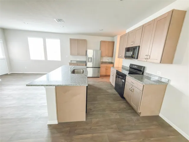 a bathroom with a shower sink and mirror