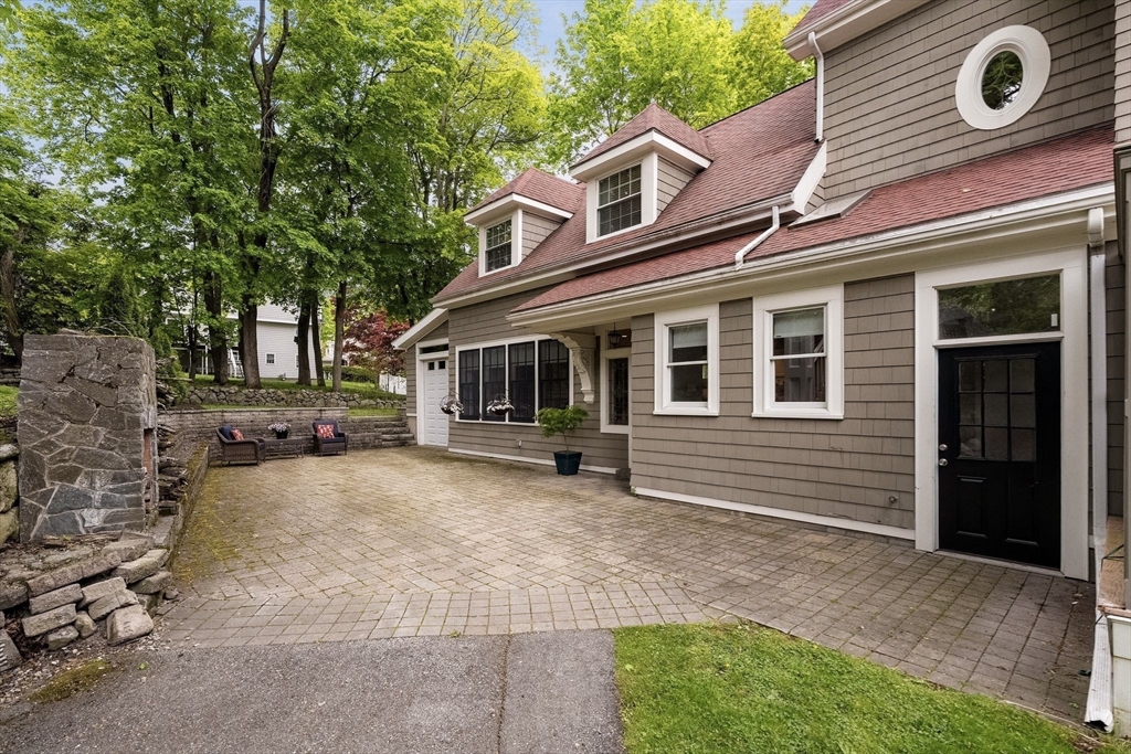165 Park Avenue, Unit 165 Arlington, MA 02476 - Photo 26 of 32 a front view of a house with a garden