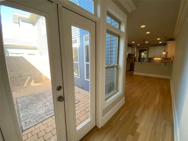 a view of livingroom and kitchen with wooden floor