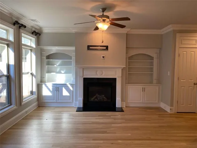 a view of a livingroom with a fireplace and window
