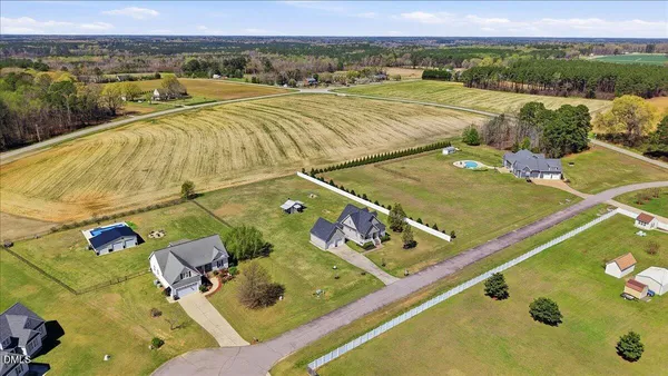 an aerial view of a pool a yard and mountain view