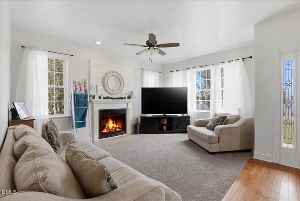 a living room with furniture a fireplace and a flat screen tv