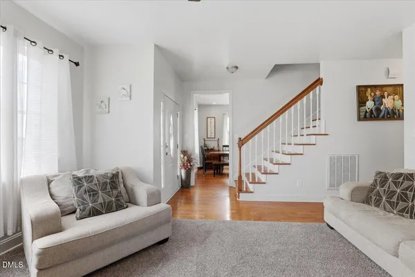 a living room with furniture and stairs