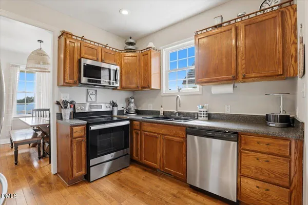 a kitchen with stainless steel appliances granite countertop a sink stove and microwave
