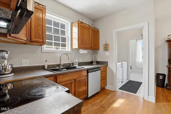 a kitchen with stainless steel appliances granite countertop a sink stove and cabinets