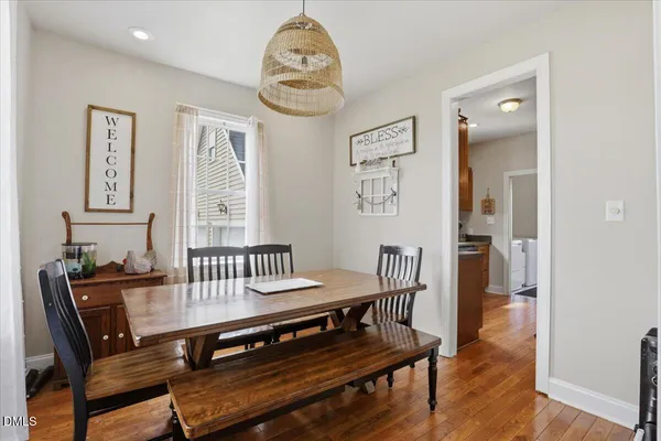 a view of a hallway with wooden floor and a bookshelf