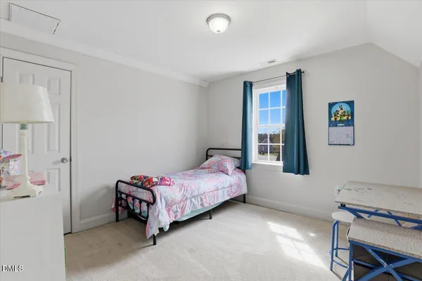 a bedroom with a bed and a desk