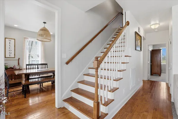 a view of entryway and hall with wooden floor