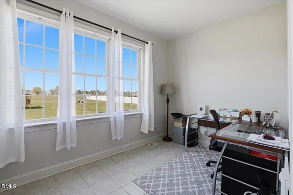 a living room with furniture a window and a table
