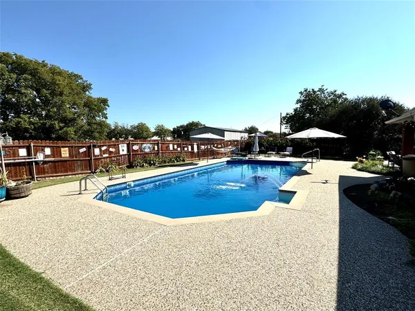 a view of a backyard with sitting area