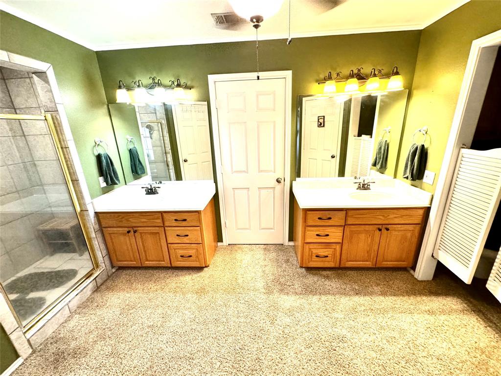 505 3rd Street Dodd City, TX 75438 - Photo 21 of 37 a bathroom with a double vanity sink a mirror and a bathtub