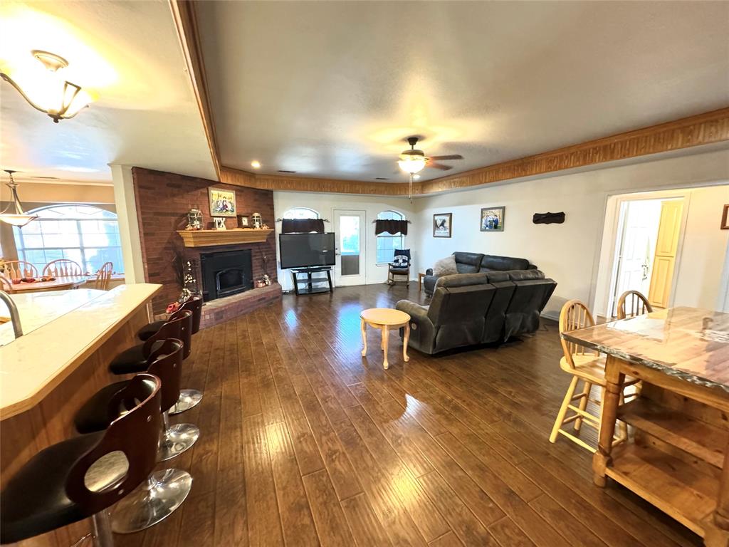505 3rd Street Dodd City, TX 75438 - Photo 28 of 37 a living room with furniture and a flat screen tv with kitchen view